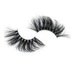 A pair of fluffy, black false eyelashes on a white background.